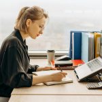 Woman at a computer writing on a list; Covenant Eyes Alternatives: The Best Accountability Apps for 2024